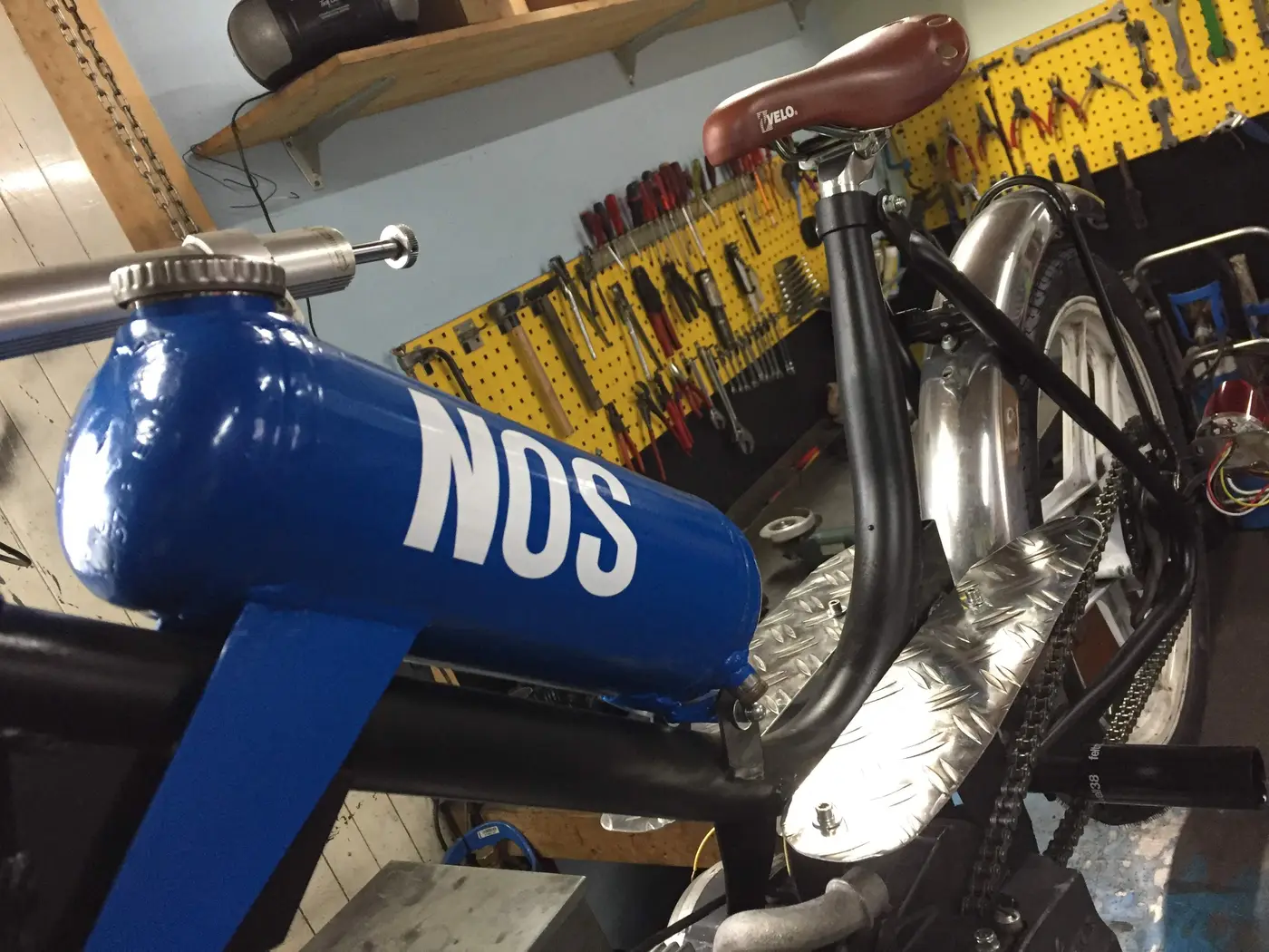 Custom-Umbau mit blauem NOS-Tank in der Werkstatt